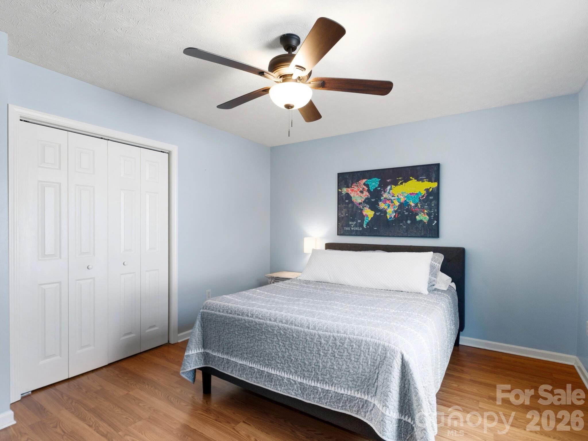 1 Mosers Place Candler, NC 28715 - Photo 22 of 32 a bedroom with a bed and a chandelier