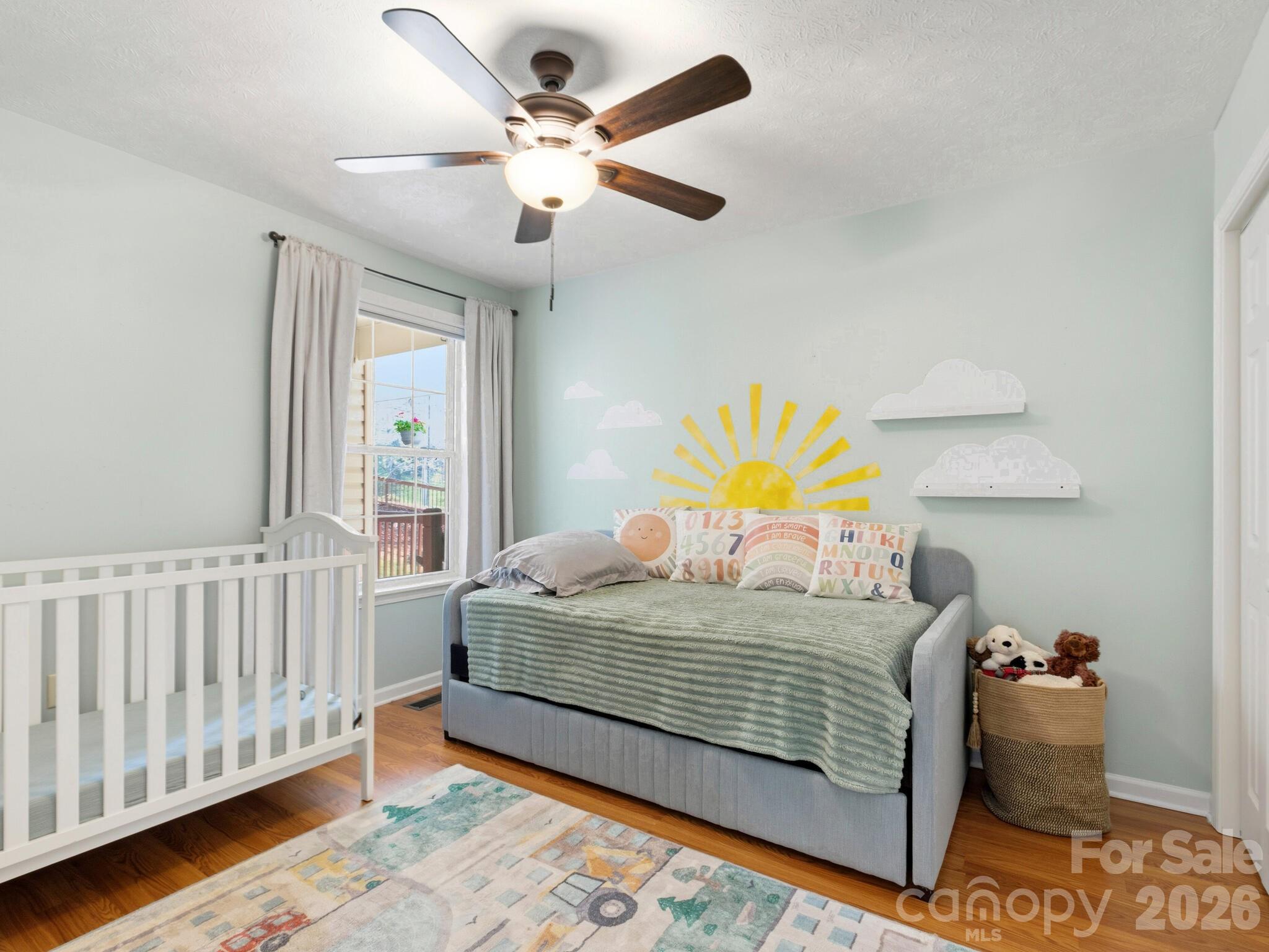 1 Mosers Place Candler, NC 28715 - Photo 24 of 32 a bedroom with a bed and a chandelier