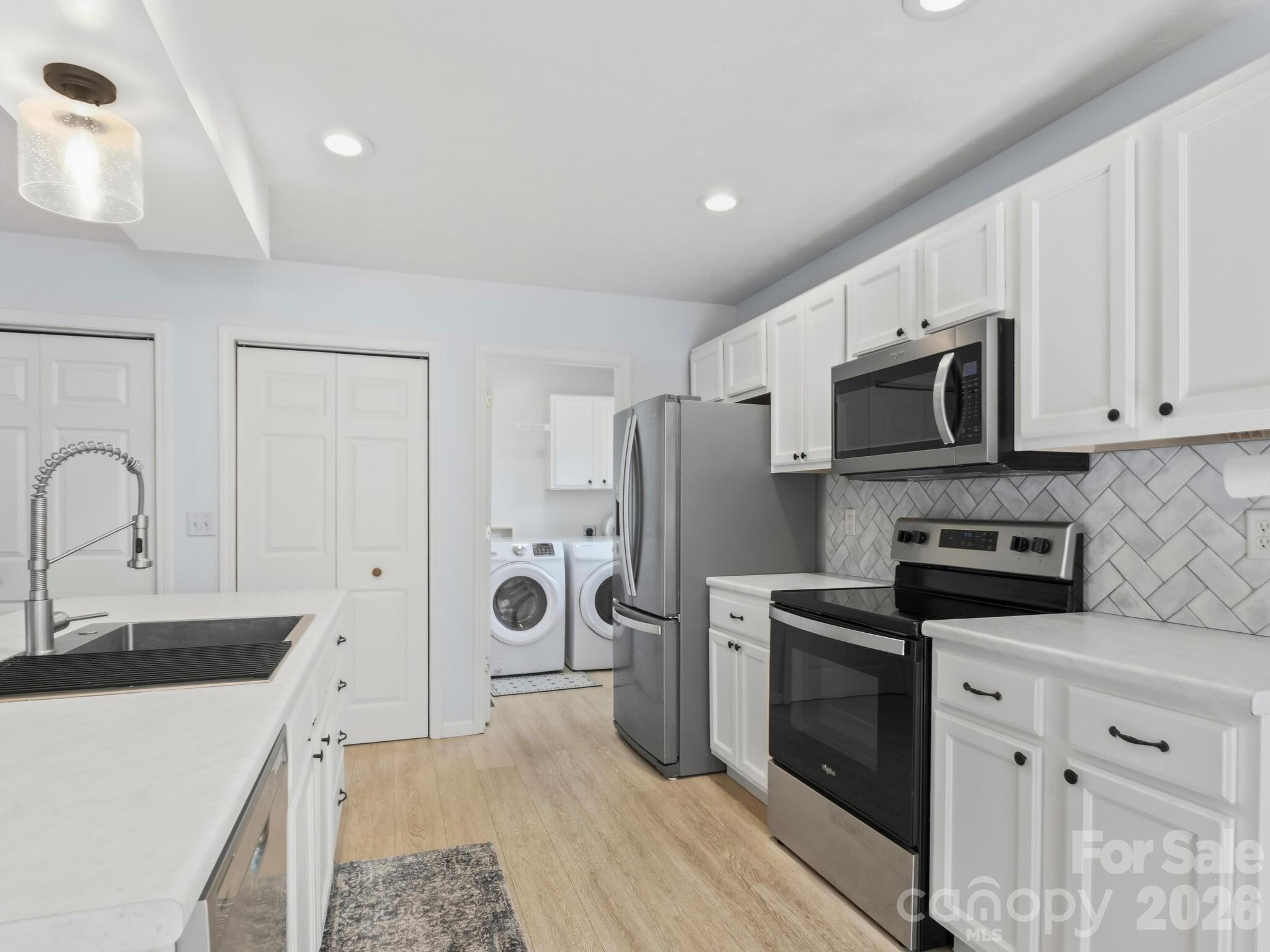 1 Mosers Place Candler, NC 28715 - Photo 10 of 32 a kitchen with stainless steel appliances a refrigerator stove microwave and sink