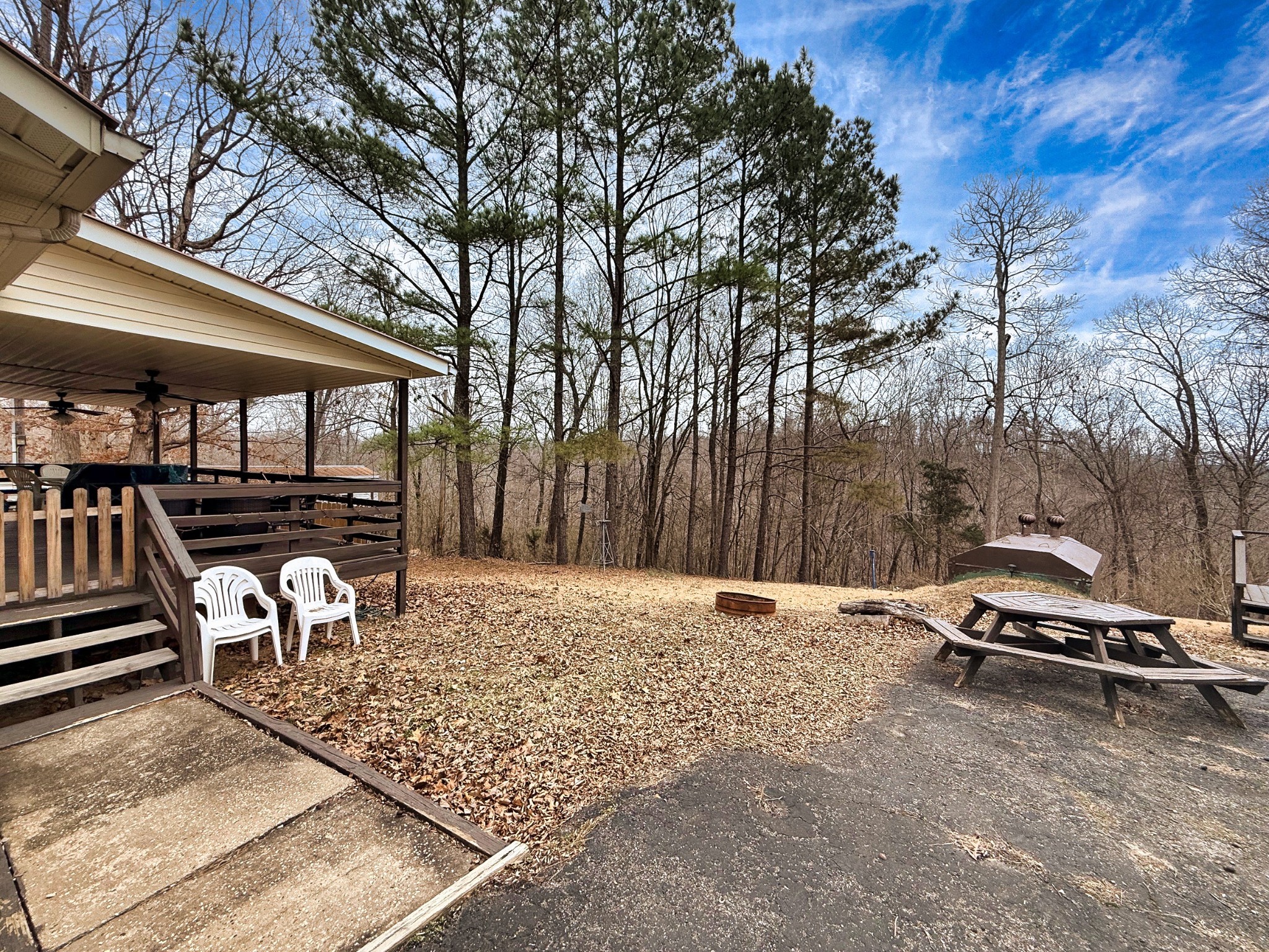 743 Brownfield Road Dover, TN 37058 - Photo 9 of 19 a backyard of a house with barbeque oven table and chairs