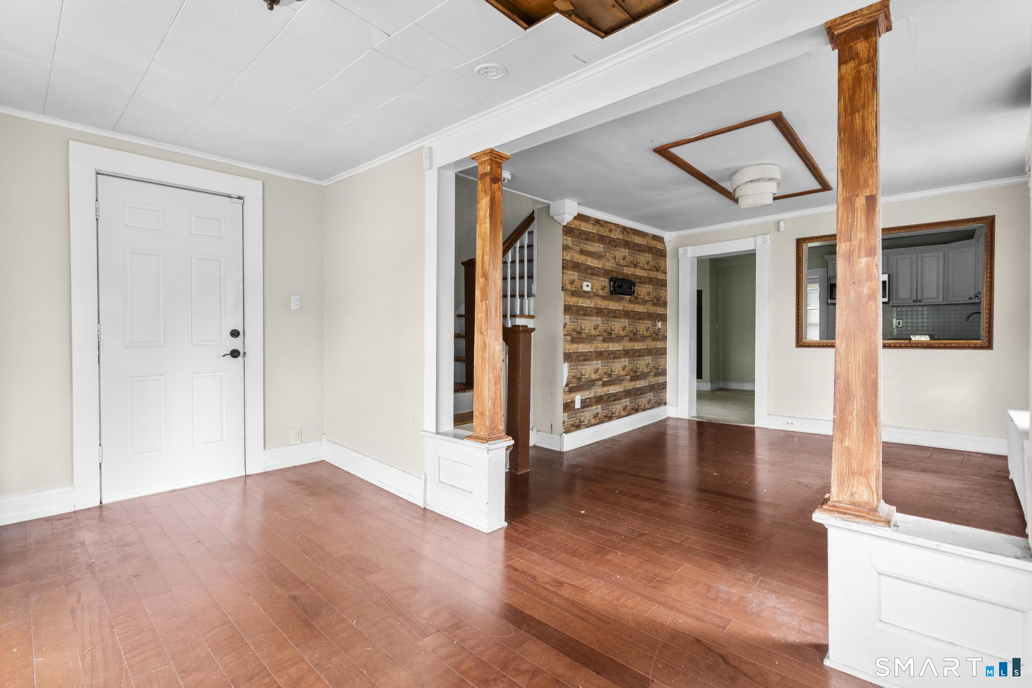 101 Meridian Street Meriden, CT 06451 - Photo 5 of 26 a view of an empty room with wooden floor and a ceiling fan