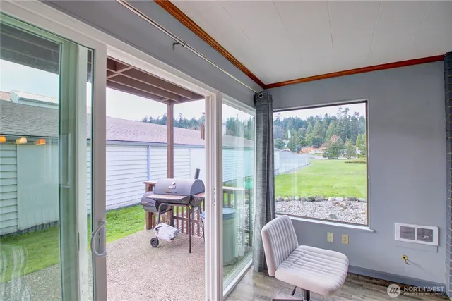 a living room with a large window and furniture
