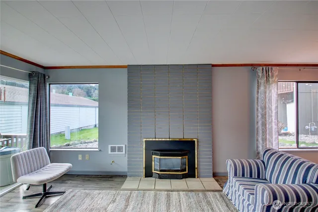 a living room with furniture and a fireplace