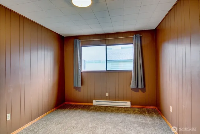 a bathroom with a granite countertop sink a toilet and a mirror