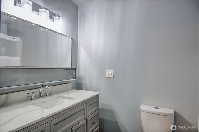 a bathroom with a toilet and a vanity