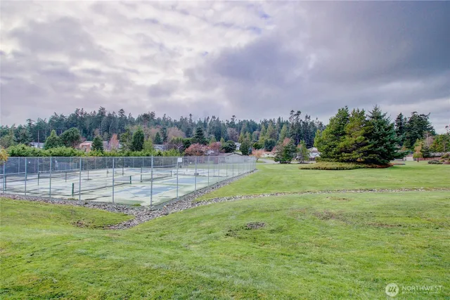 a view of a brick house with a small yard