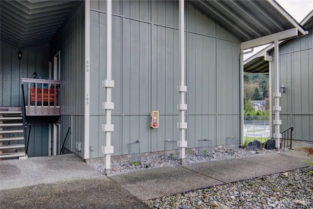 a backyard of a house with table and chairs