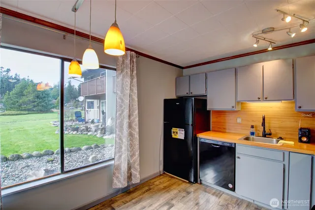 a kitchen with a refrigerator and a sink