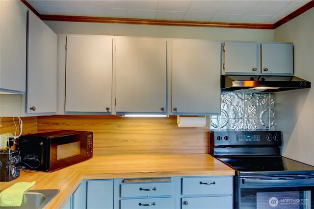 a kitchen with an oven and cabinets