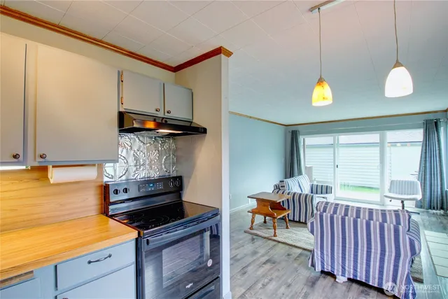 a kitchen with a stove and a window