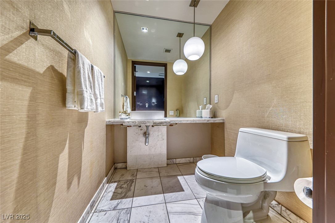 4381 West Flamingo Road, Unit 901 Las Vegas, NV 89103 - Photo 26 of 58 Half bathroom featuring toilet