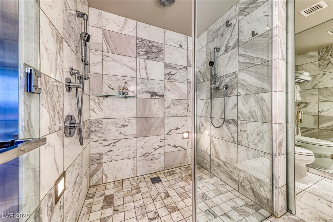 4381 West Flamingo Road, Unit 901 Las Vegas, NV 89103 - Photo 30 of 58 Bathroom featuring toilet, a shower stall, and a bidet