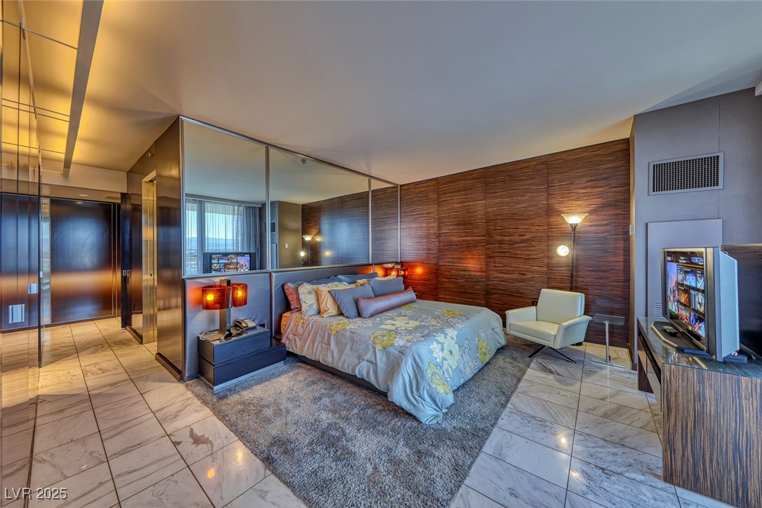 4381 West Flamingo Road, Unit 901 Las Vegas, NV 89103 - Photo 35 of 58 Bedroom featuring marble look tile flooring and elevator