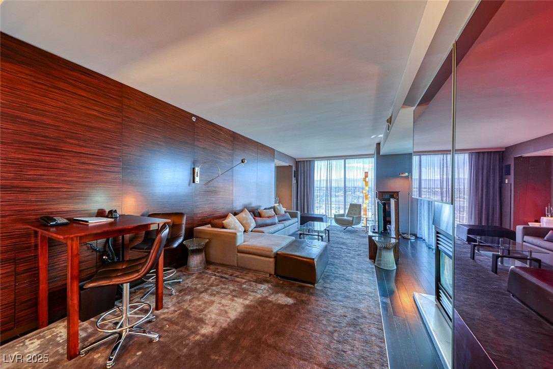 4381 West Flamingo Road, Unit 901 Las Vegas, NV 89103 - Photo 37 of 58 Living room featuring wood finished floors and a wall of windows