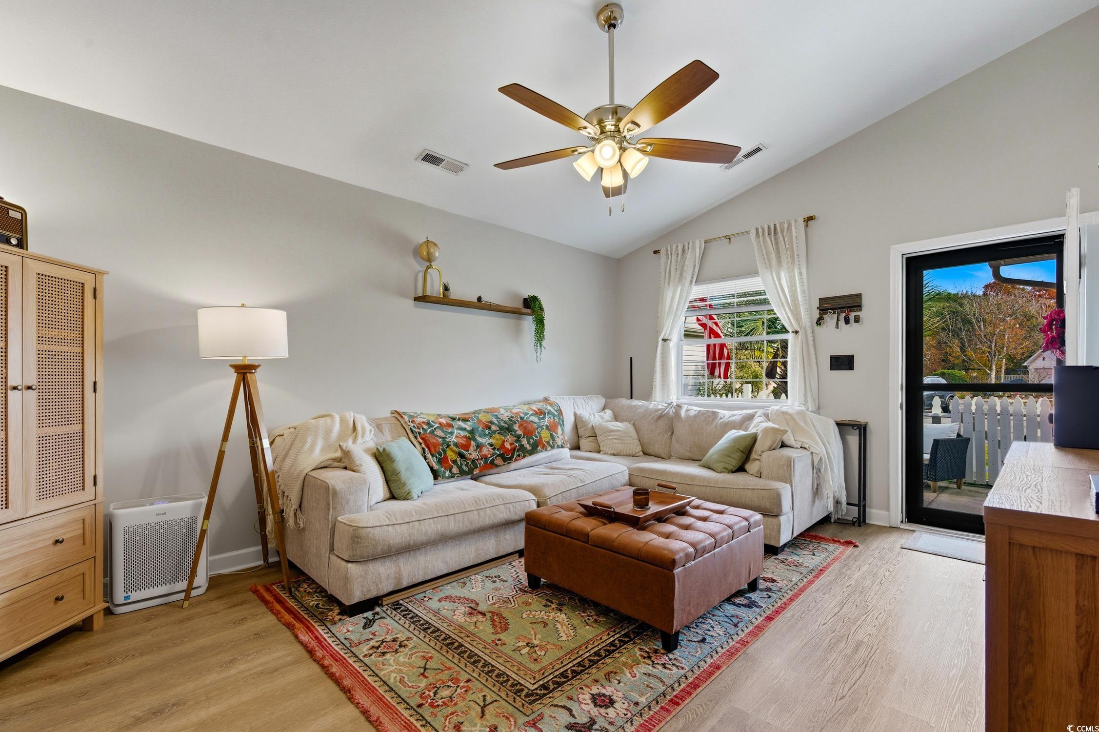 418 Chesterfield Court Myrtle Beach, SC 29577 - Photo 3 of 18 Living area with vaulted ceiling, light wood-style floors, ceiling fan, and heating unit