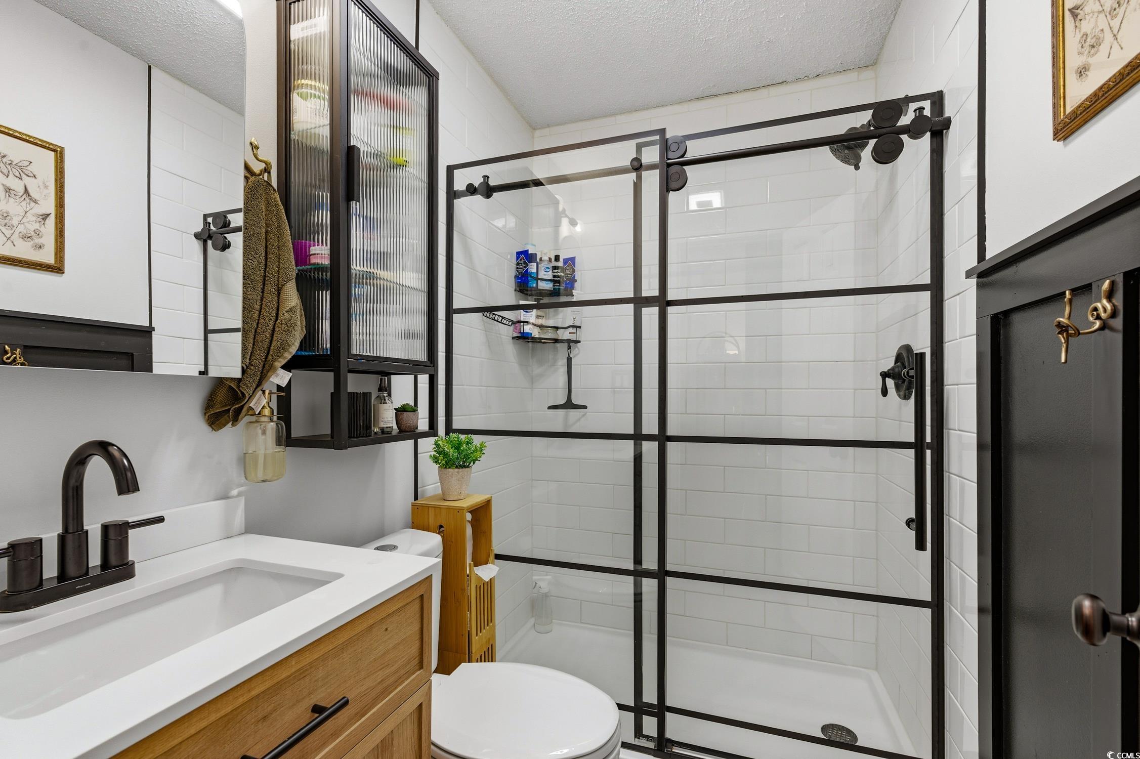 418 Chesterfield Court Myrtle Beach, SC 29577 - Photo 8 of 18 Carpeted bedroom featuring a closet, a textured ceiling, and ceiling fan