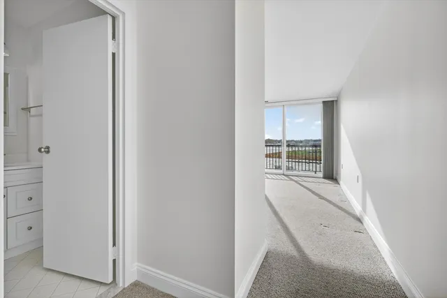 an entryway with wooden floor and cabinet