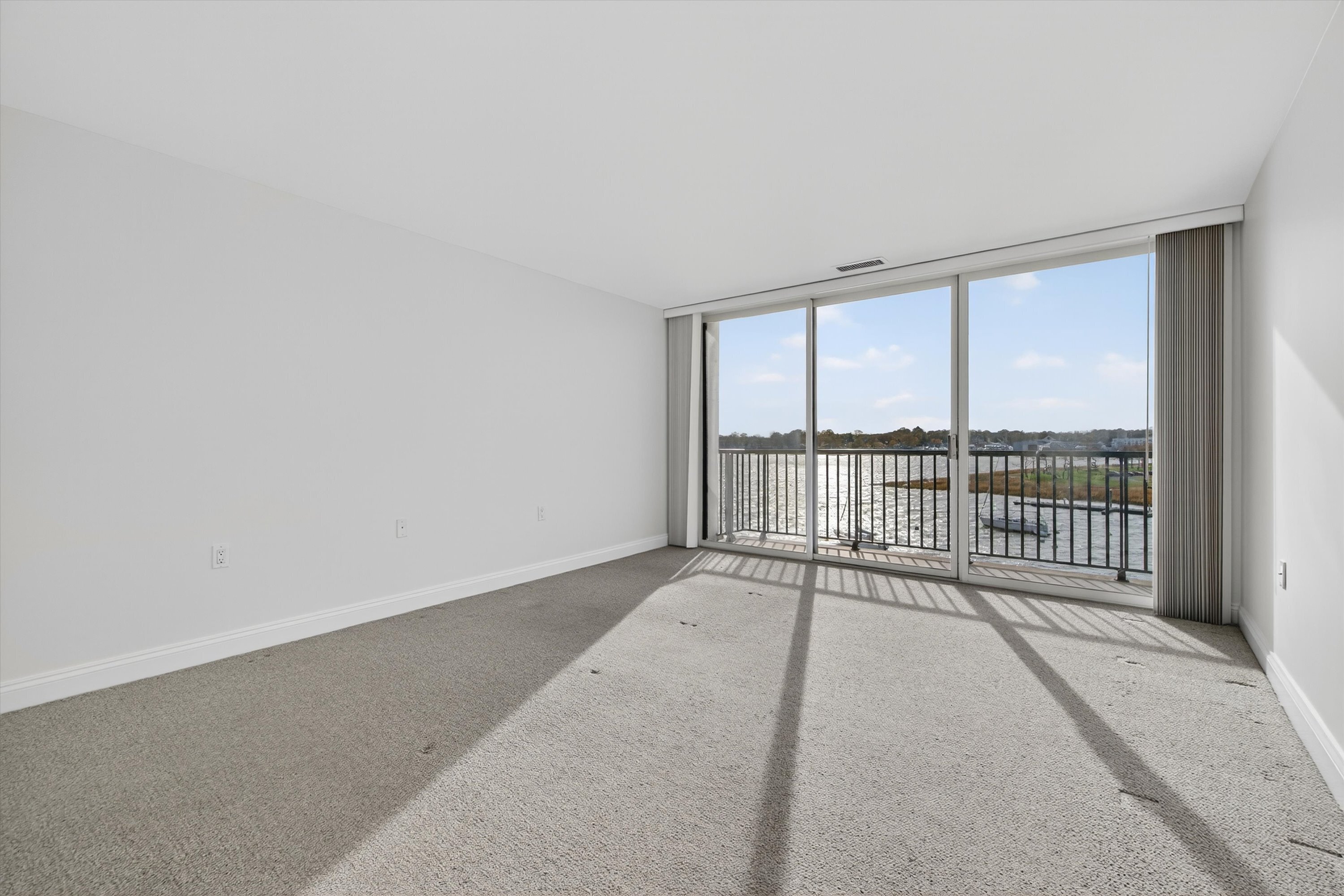 100 Seaview Avenue, Unit 3I Norwalk, CT 06855 - Photo 17 of 40 a view of a room with wooden floor and a ceiling fan
