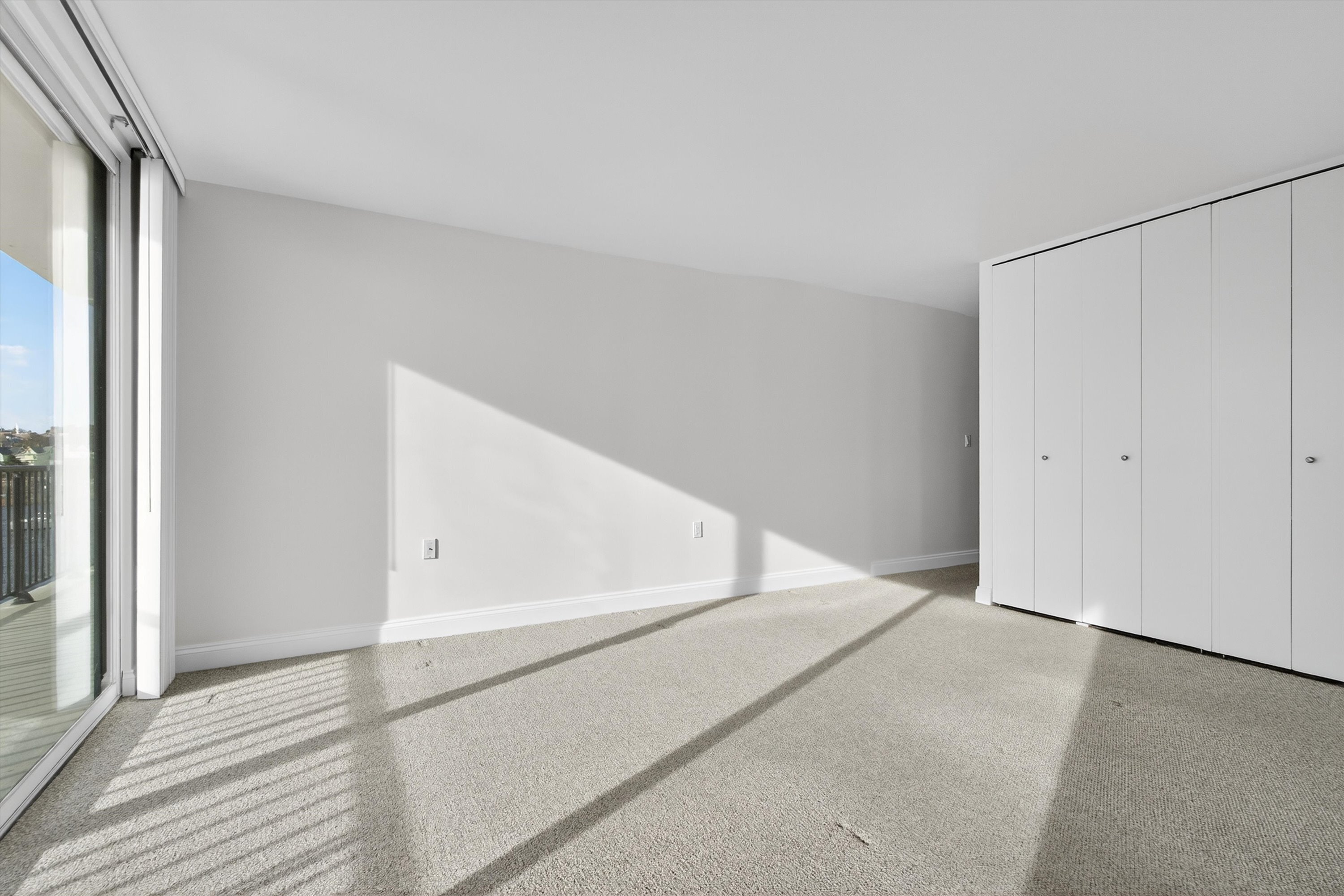 100 Seaview Avenue, Unit 3I Norwalk, CT 06855 - Photo 19 of 40 a view of an empty room with wooden floor and a window