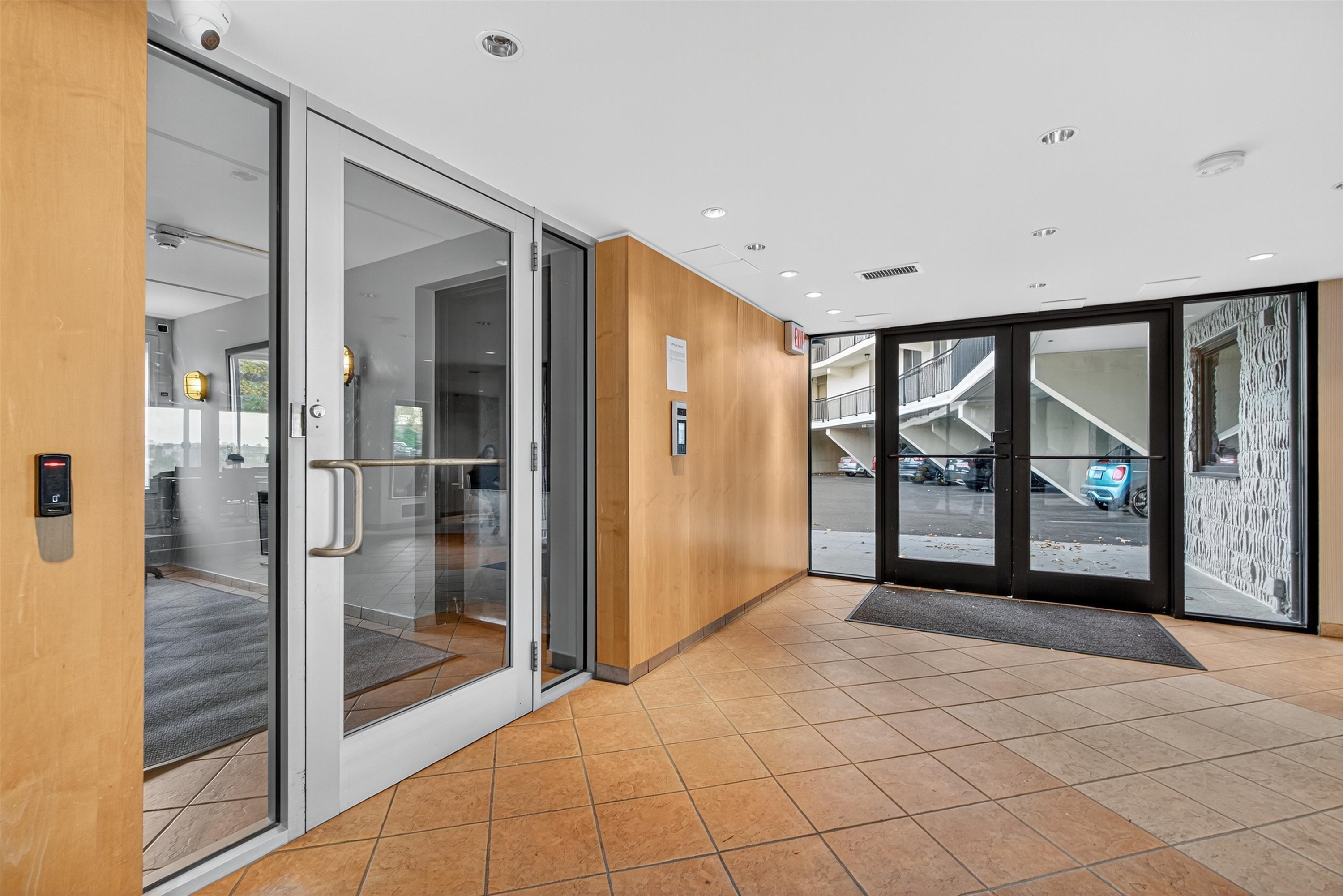 100 Seaview Avenue, Unit 3I Norwalk, CT 06855 - Photo 27 of 40 a view of a hallway with wooden floor and glass door