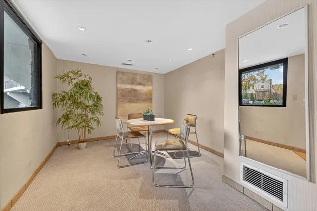 a view of a dining room with furniture and a potted plant
