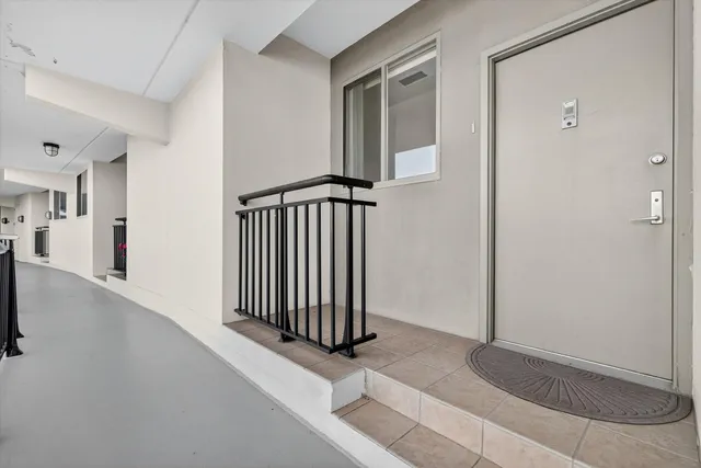an entryway with wooden floor and staircase