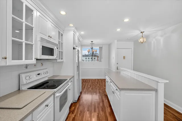 a kitchen with a sink a stove and a microwave