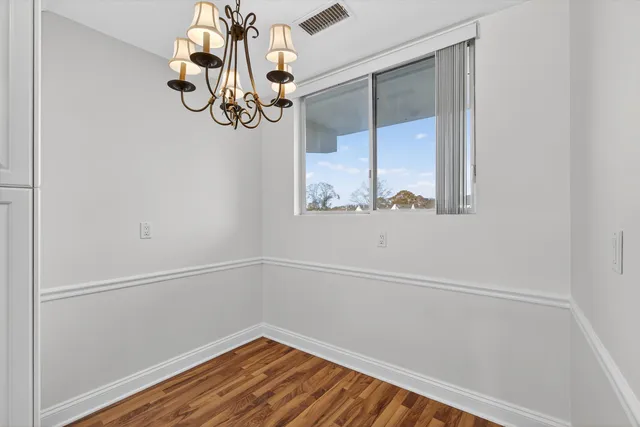 a view of a small space with wooden floor and a window