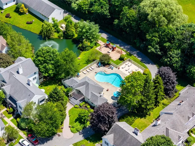 an aerial view of a house with a yard and garden