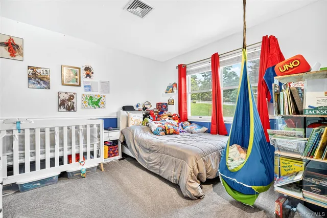 a bedroom with bed and a two windows