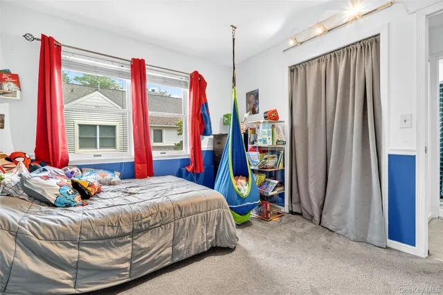 a bedroom with bed and a window