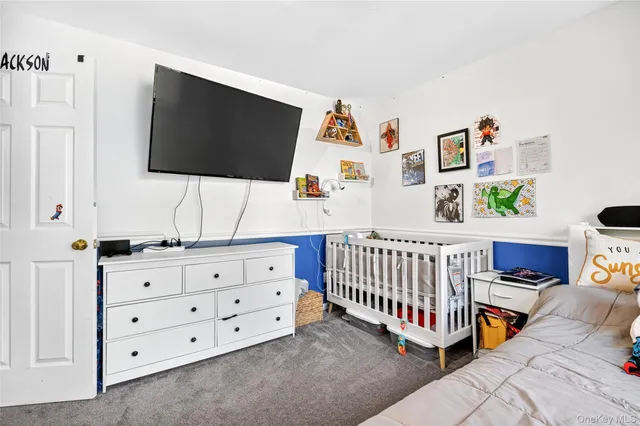 a bedroom with furniture and a flat screen tv
