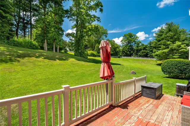 a view of a deck with a chair and floor to ceiling window