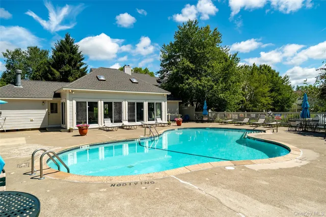 a view of swimming pool with seating space