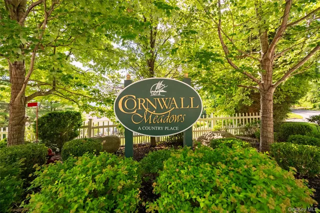 a sign that is on a pole on a wall