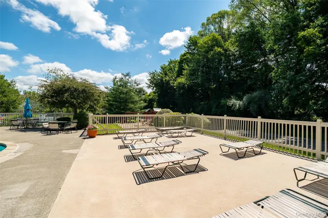 a view of a patio with a table and chairs