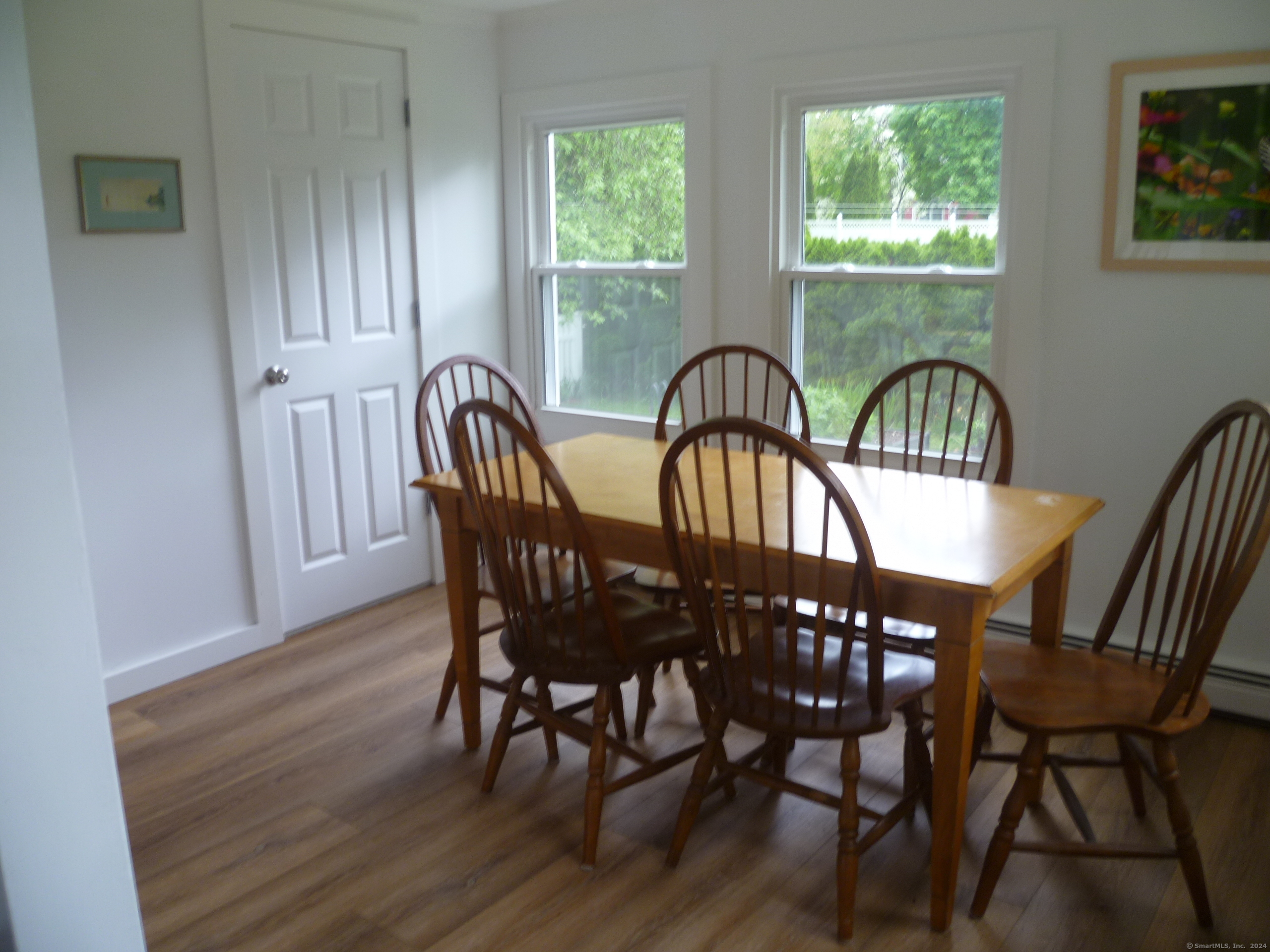 6 Sunset Lane Clinton, CT 06413 - Photo 12 of 27 a view of a a dining room with furniture window chandelier and wooden floor