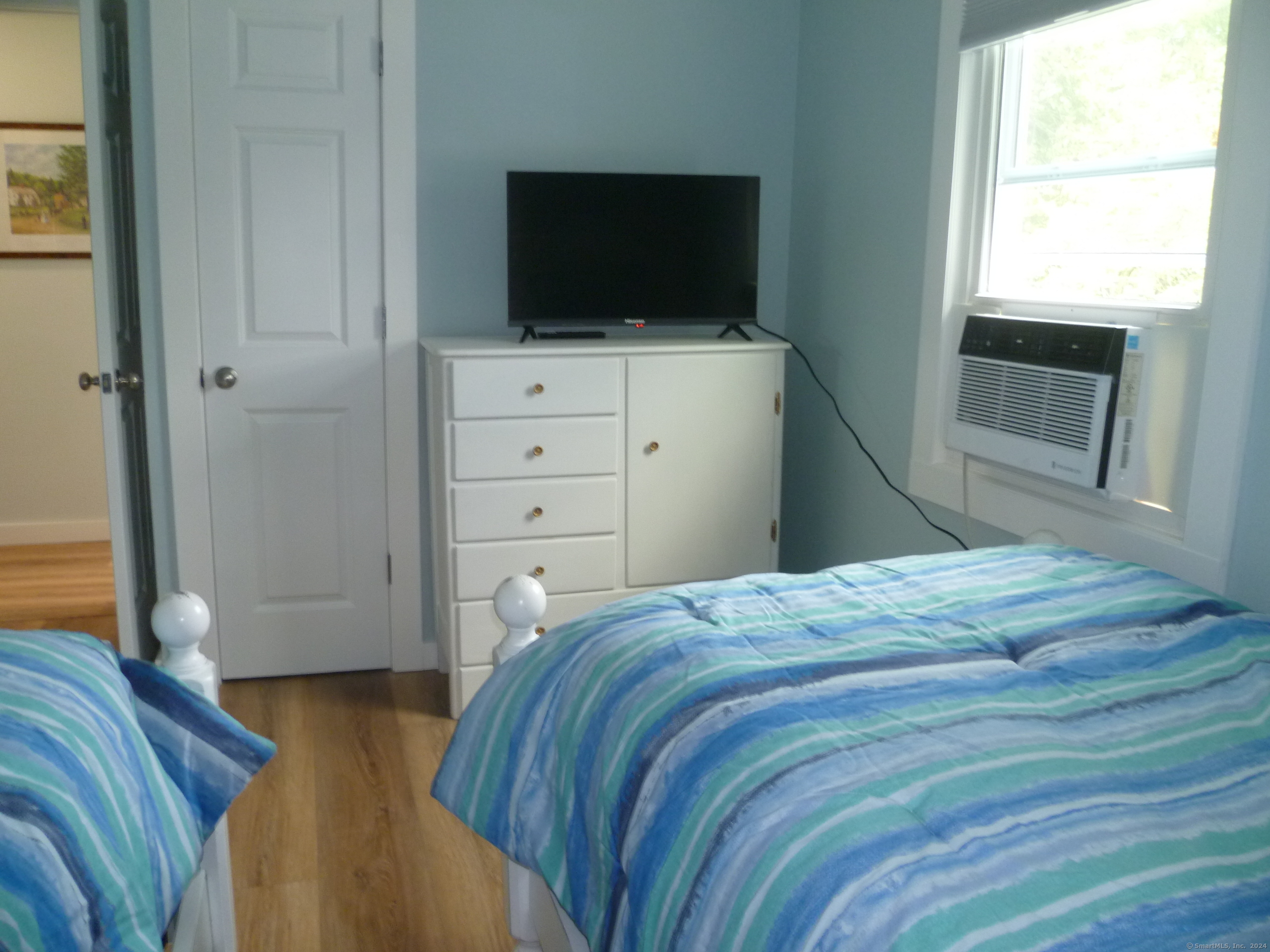 6 Sunset Lane Clinton, CT 06413 - Photo 17 of 27 a bedroom with a bed and a flat screen tv