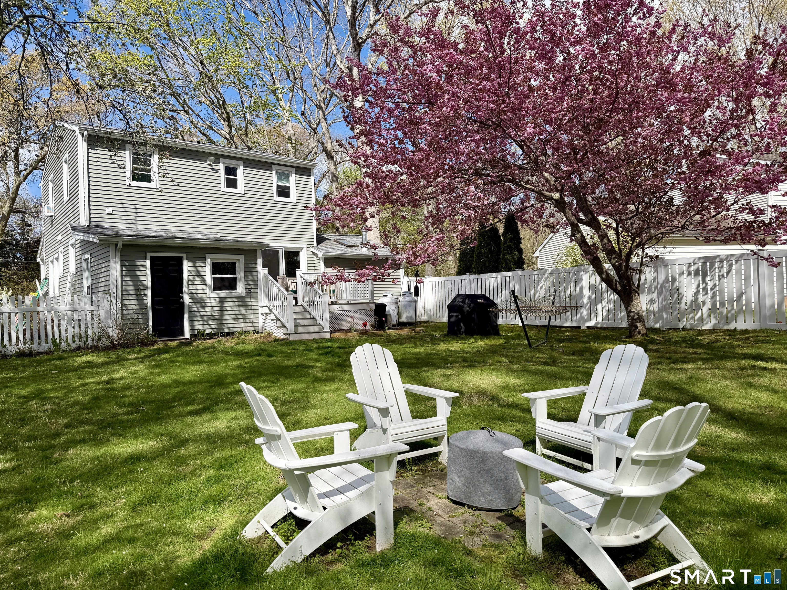 6 Sunset Lane Clinton, CT 06413 - Photo 2 of 27 a view of yard with outdoor seating and trees