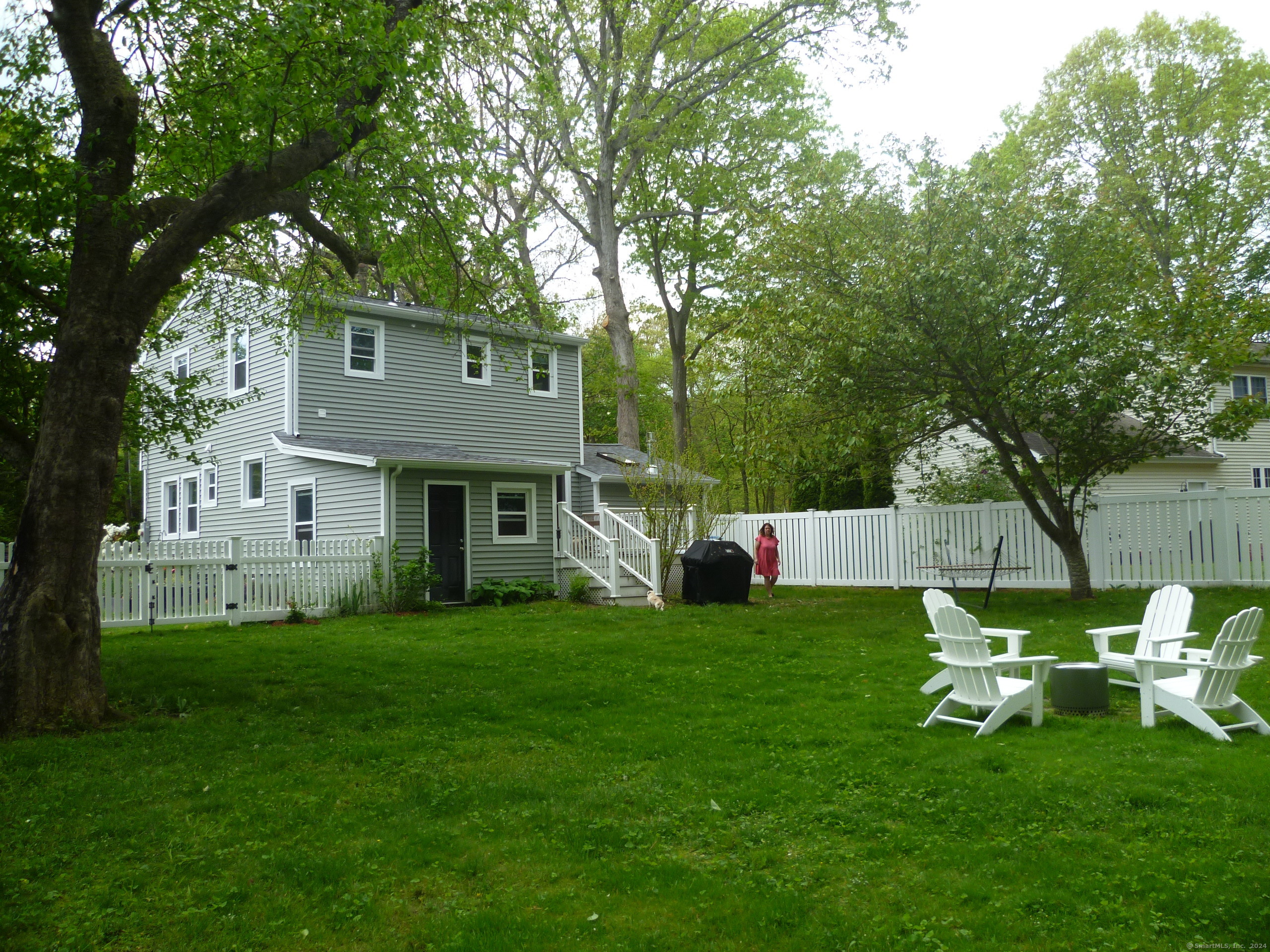 6 Sunset Lane Clinton, CT 06413 - Photo 24 of 27 a view of a chair and table in backyard of the house