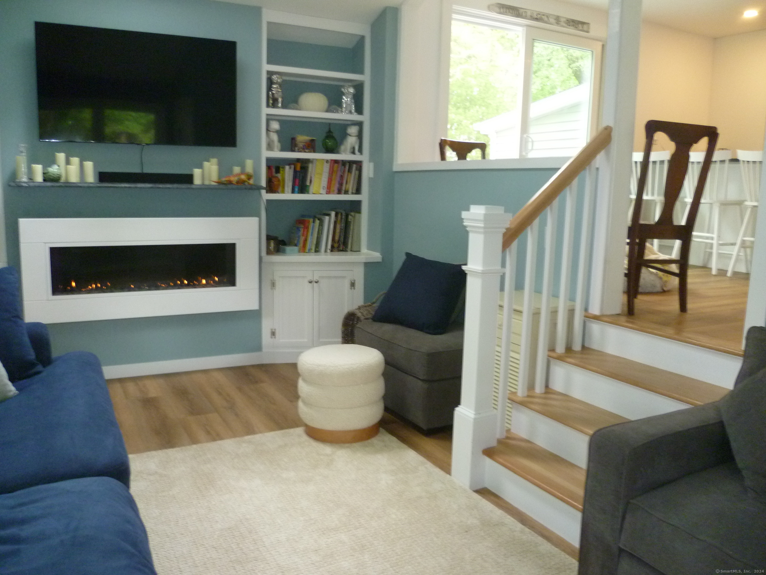 6 Sunset Lane Clinton, CT 06413 - Photo 9 of 27 a living room with furniture a flat screen tv and a fireplace