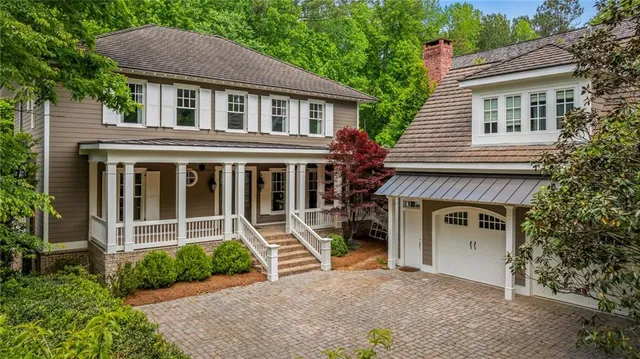 a view of house with a yard and a large window