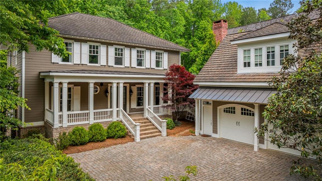 a view of house with a yard and a large window