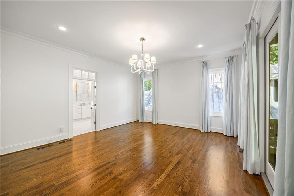 9179 Selborne Lane Chattahoochee Hills, GA 30268 - Photo 11 of 53 a view of an empty room with wooden floor and a window