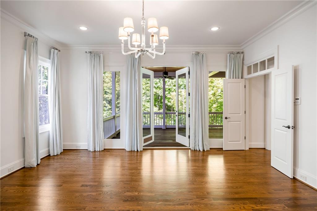 9179 Selborne Lane Chattahoochee Hills, GA 30268 - Photo 13 of 53 a view of a livingroom with a chandelier wooden floor and windows