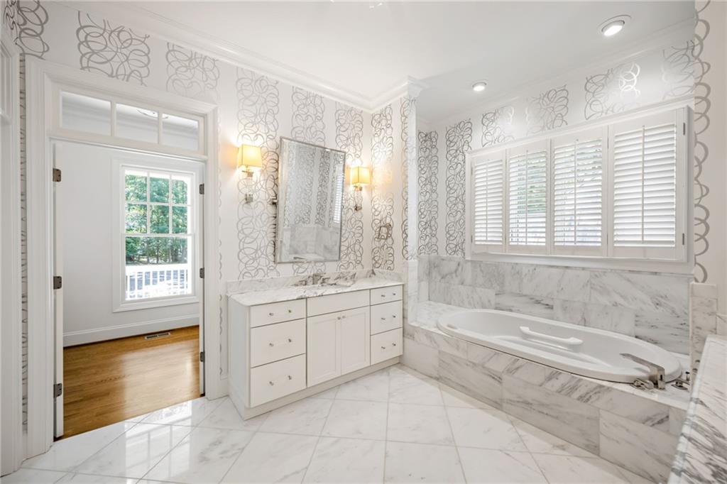 9179 Selborne Lane Chattahoochee Hills, GA 30268 - Photo 14 of 53 a spacious bathroom with a tub sink shower and mirror