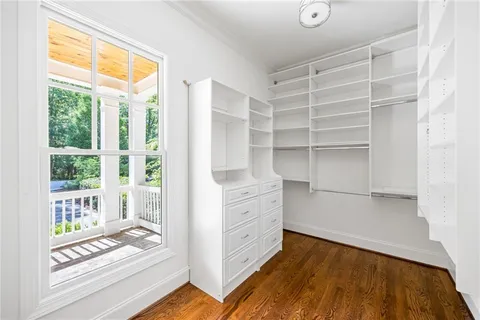 a view of walk in closet with empty racks