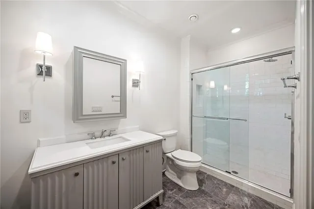 a bathroom with a toilet a sink and shower
