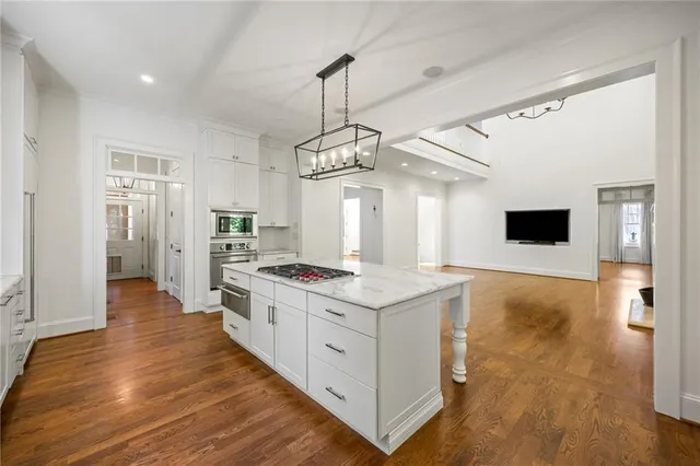 a kitchen with stainless steel appliances granite countertop a stove and a refrigerator