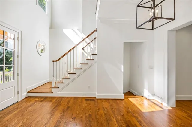 a view of entryway and hall with wooden floor